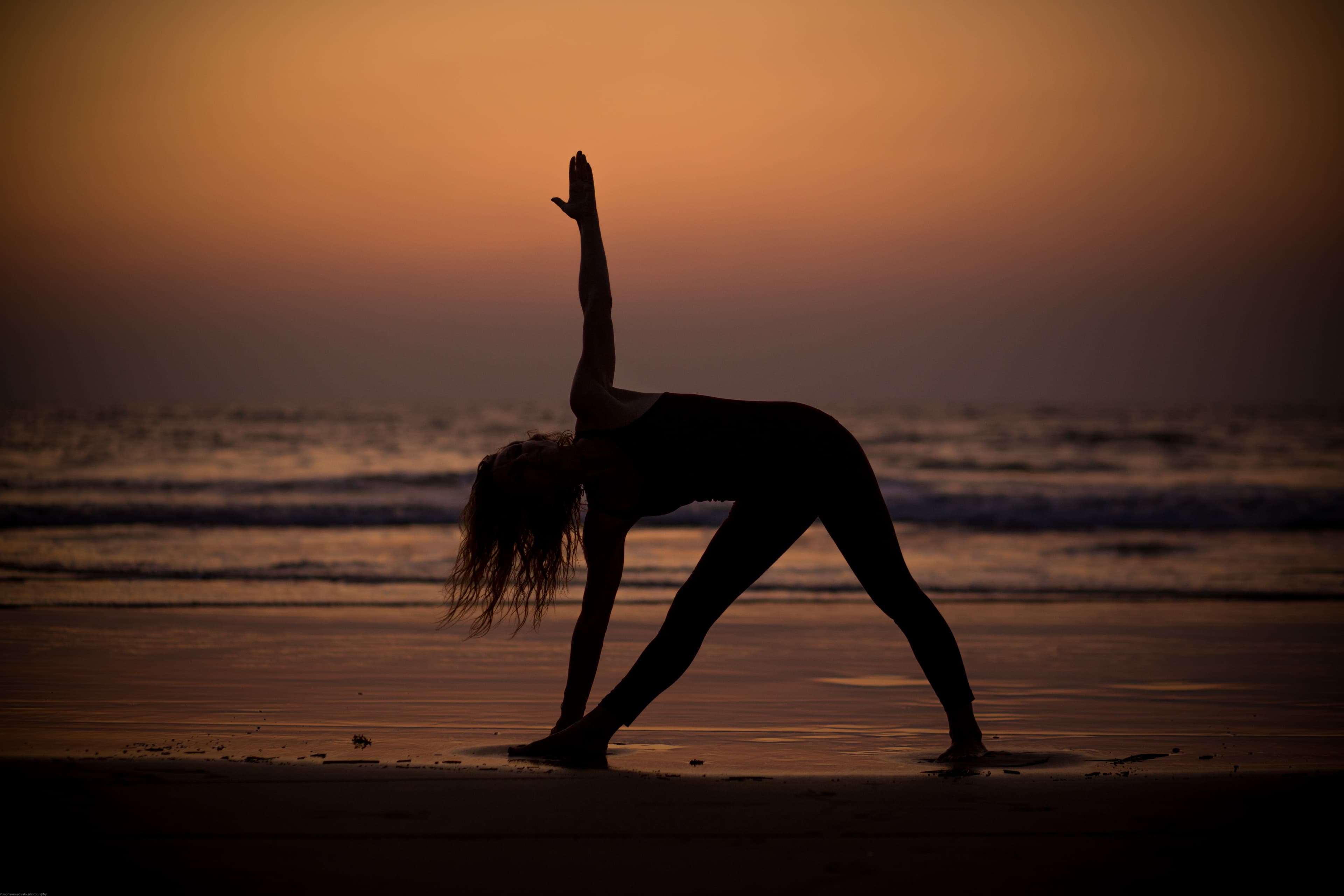 Group yoga on the beach